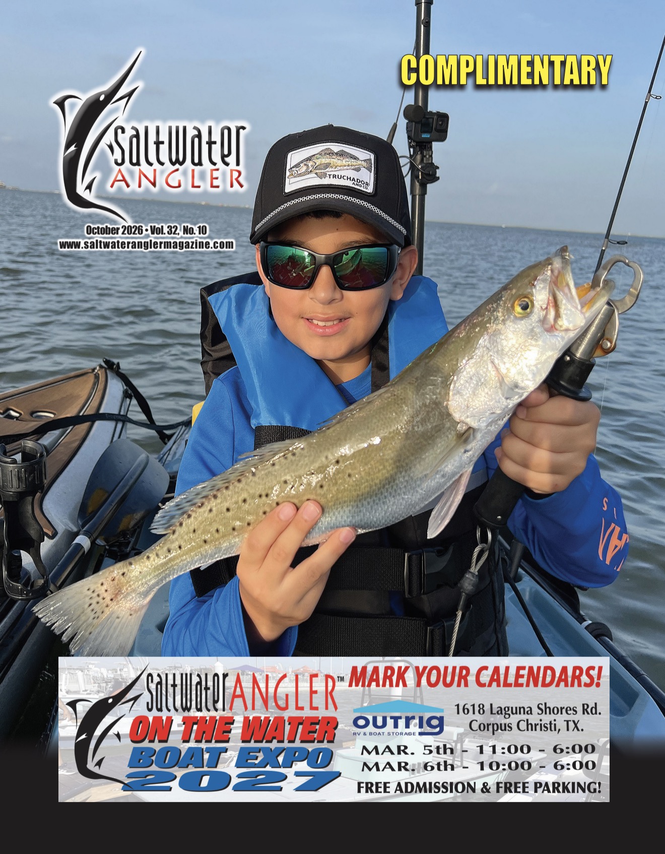 Saltwater Angler Magazine October 2026 cover featuring a young angler holding a speckled trout
